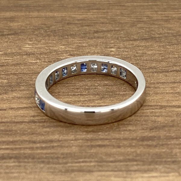 Silver band with blue sapphire stones.