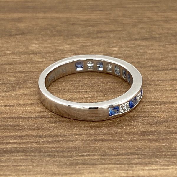 White gold band with sapphires and diamonds.