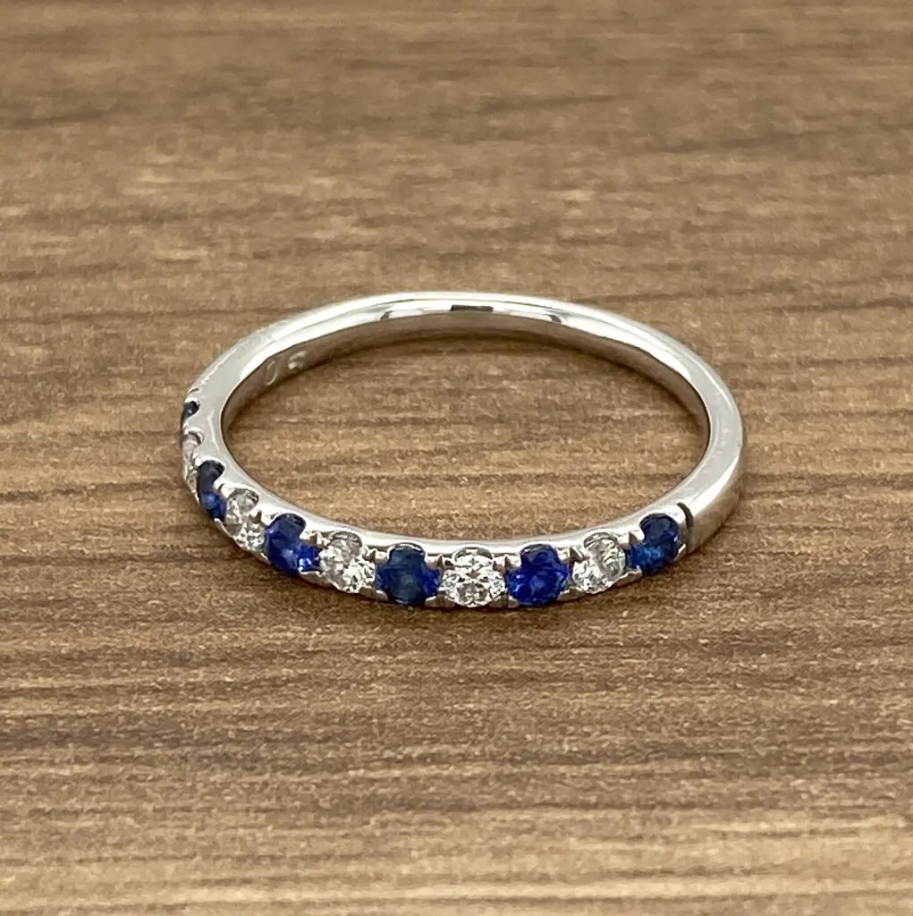 White gold band with blue sapphires and diamonds.