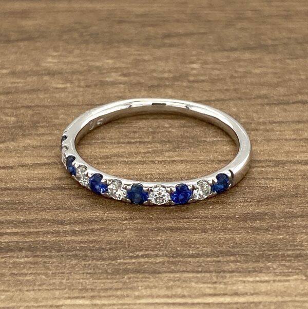 White gold band with blue sapphires and diamonds.