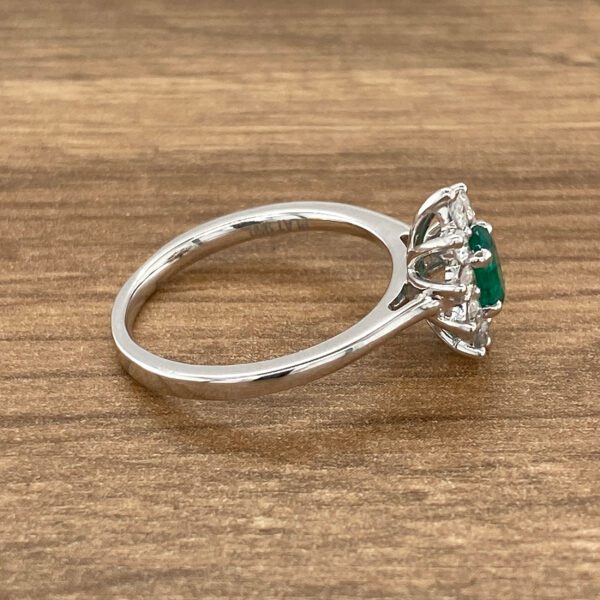 Emerald and diamond halo engagement ring.