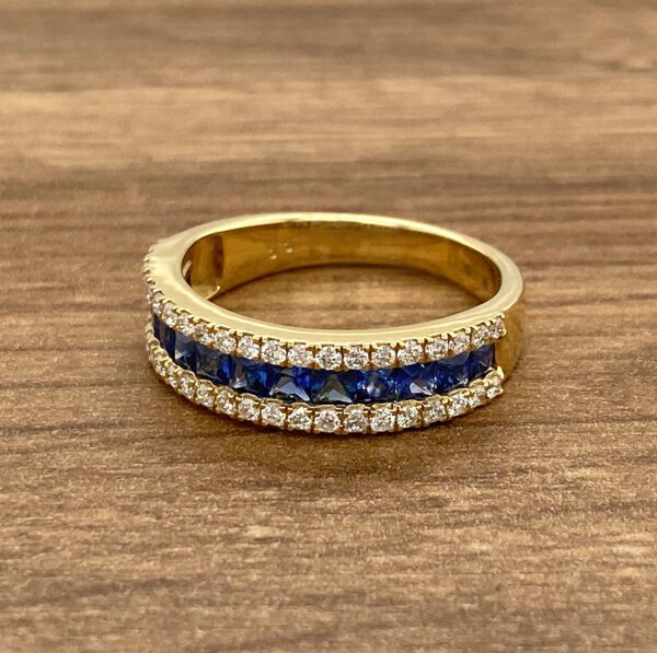 Gold band with blue sapphire and diamond accents.