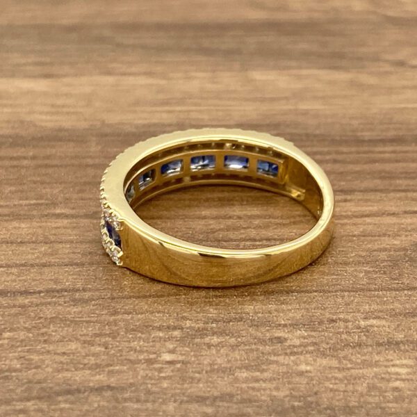 Gold band with blue sapphire stones.