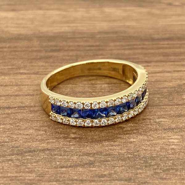 Gold band with blue sapphire and diamond accents.