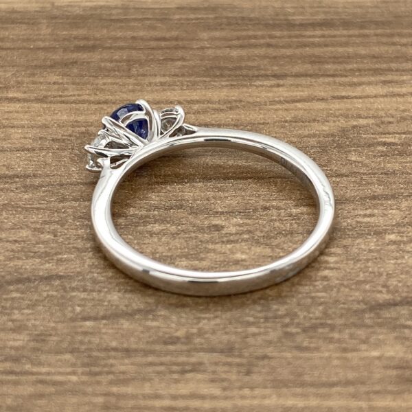 Silver ring with a blue sapphire stone.