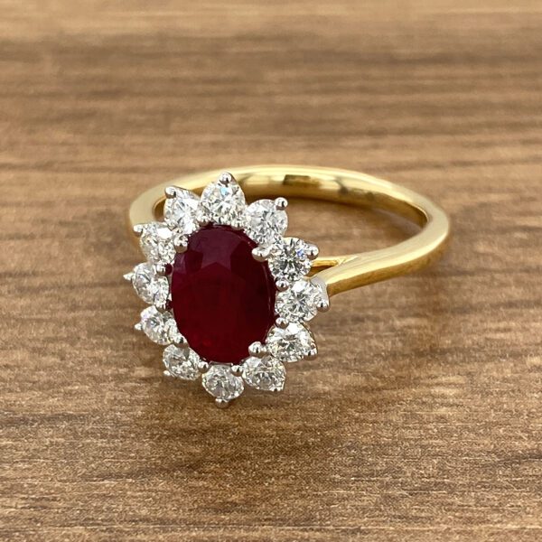 Gold ring with ruby and diamond halo.