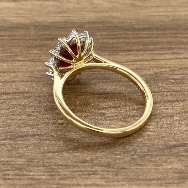 Gold ring with red ruby and diamonds.