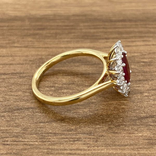 Gold ring with red ruby and diamonds.