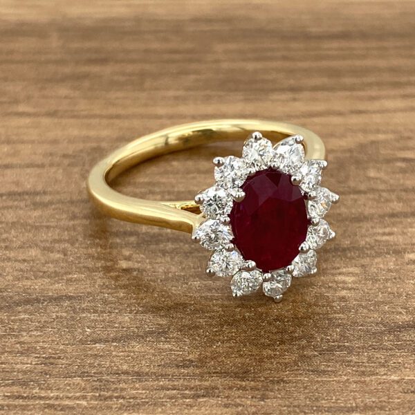 Gold ring with ruby and diamond halo.