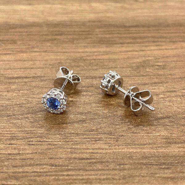 Silver earrings with blue sapphire stones.