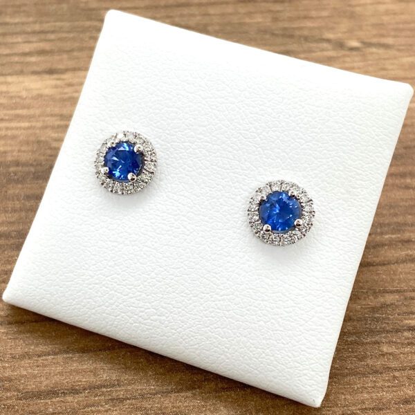 Blue sapphire and diamond halo earrings.