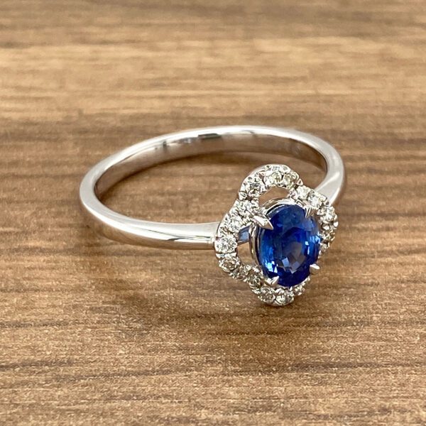 Oval sapphire ring with diamond halo.