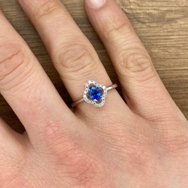 Diamond ring with a blue sapphire.