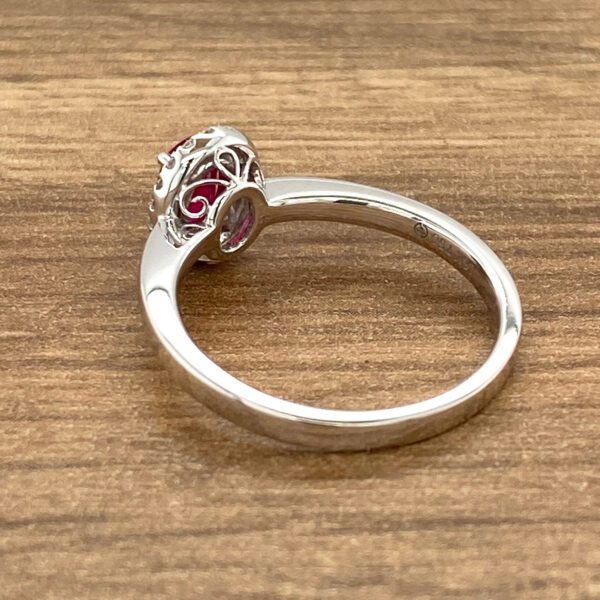 Silver ring with a red gemstone.