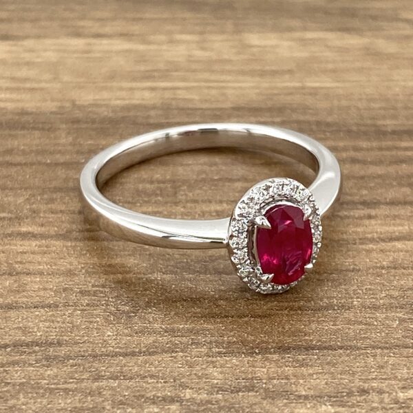 Ruby and diamond halo engagement ring.