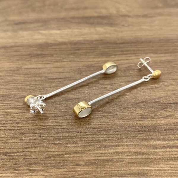 Gold and silver long drop earrings.