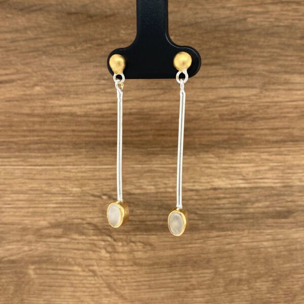 Gold and silver dangle earrings with white stones.