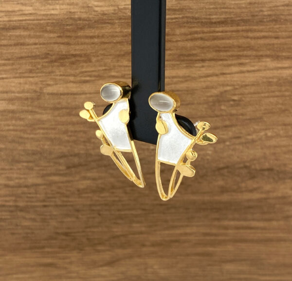 Gold and white abstract earrings.