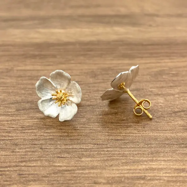 Silver flower stud earrings with gold center.