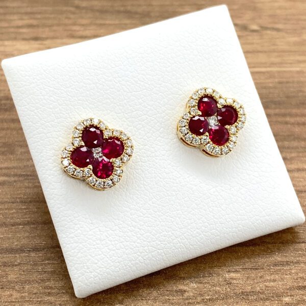 Gold ruby and diamond flower earrings.