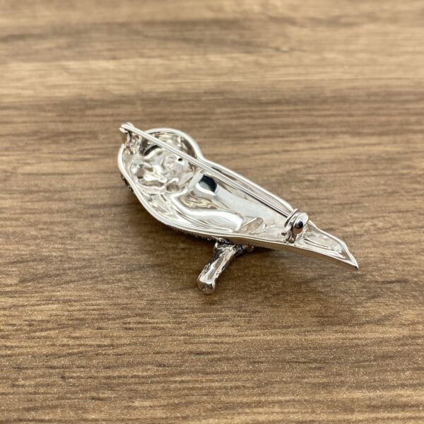 Silver bird brooch with pin on back.