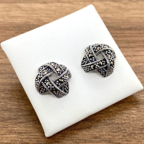 Silver knot earrings with marcasite stones.