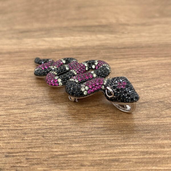 Diamond and ruby jeweled snake pendant.