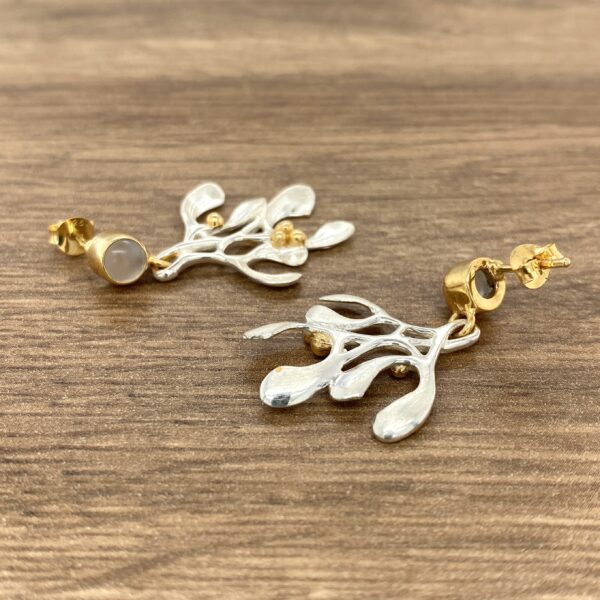 Silver and gold twig earrings with stones.