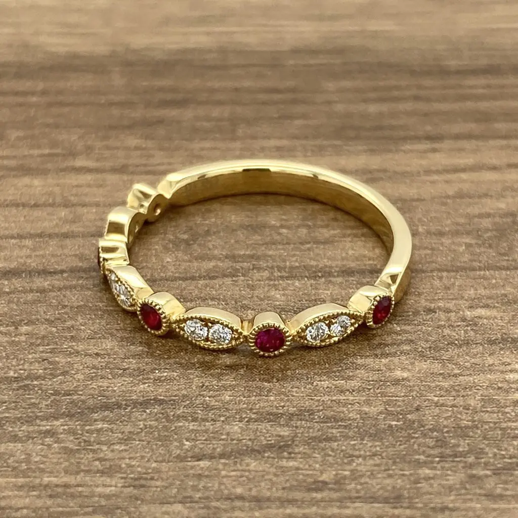 Gold ring with ruby and diamond accents.