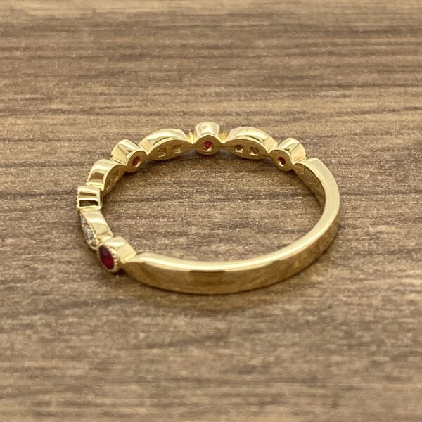 Gold band with ruby and diamond accents.