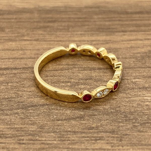 Gold ring with red and white stones.