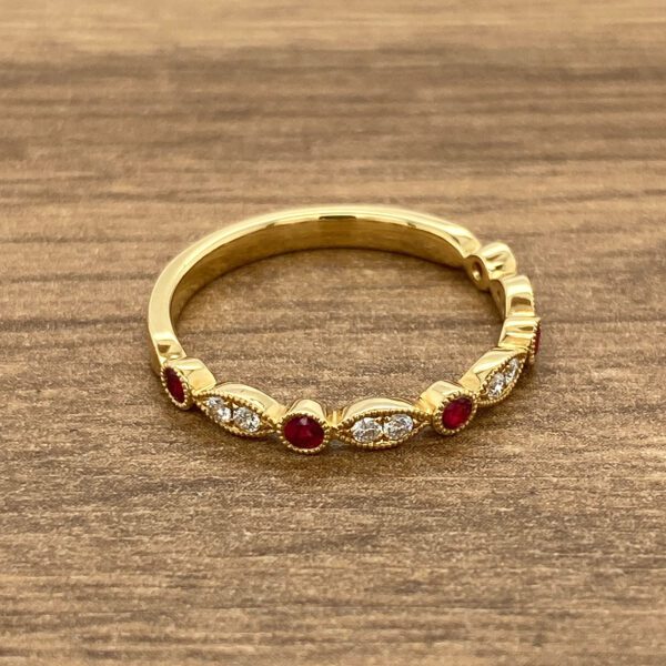 Gold band with ruby and diamond accents.