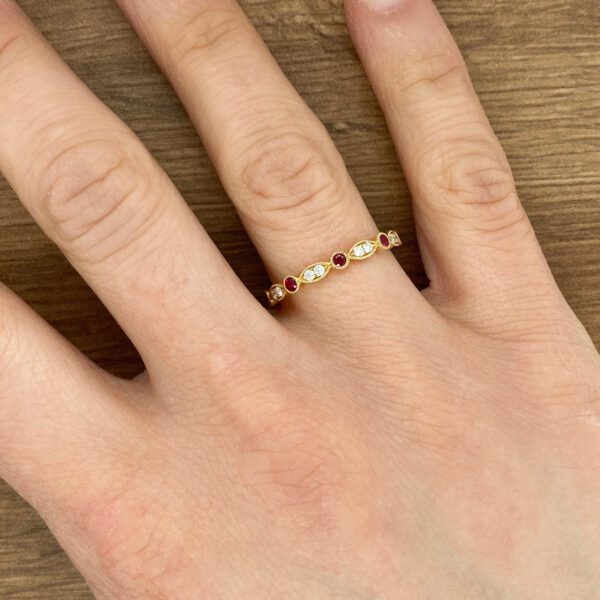 Gold ring with red and white stones.