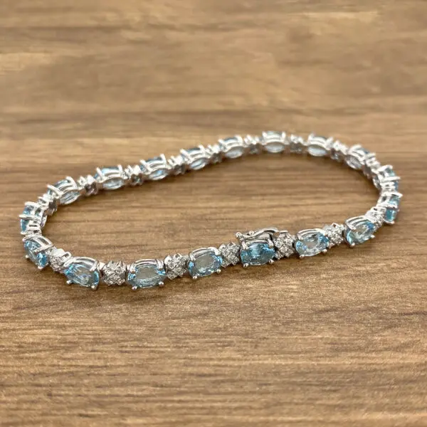 Silver aquamarine and diamond tennis bracelet.