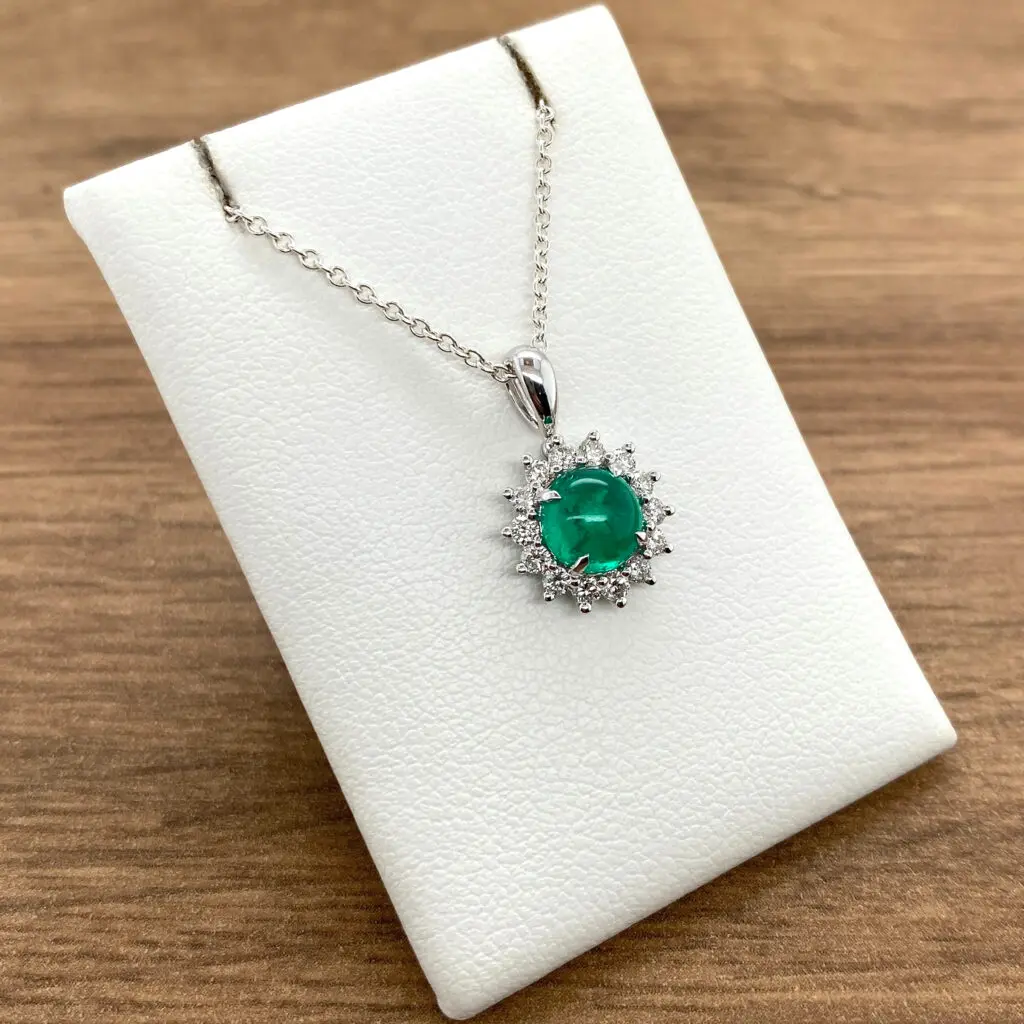 Emerald and diamond pendant necklace.