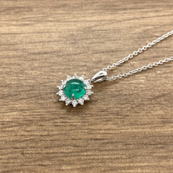 Emerald and diamond pendant necklace.