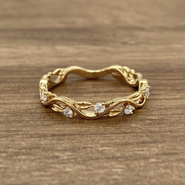 Gold band with diamond vine design.