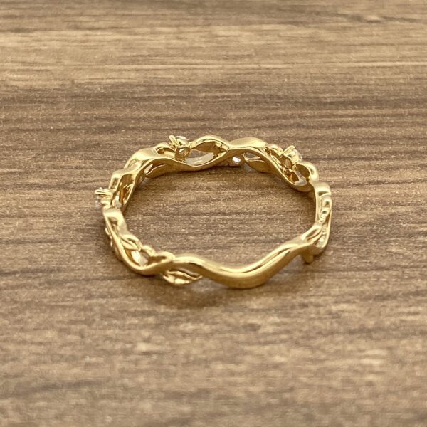 Gold ring with leaf and diamond design.