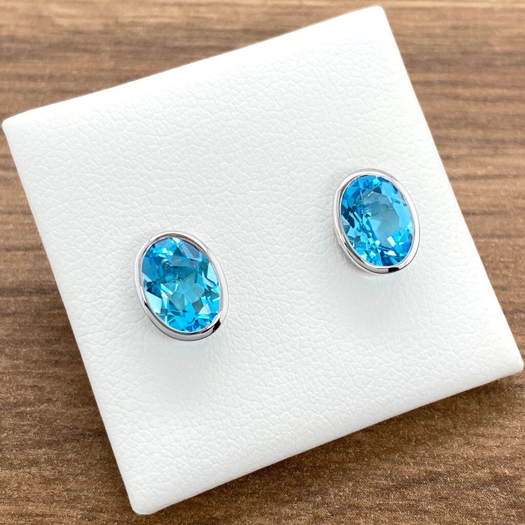 Oval blue topaz earrings in white gold.