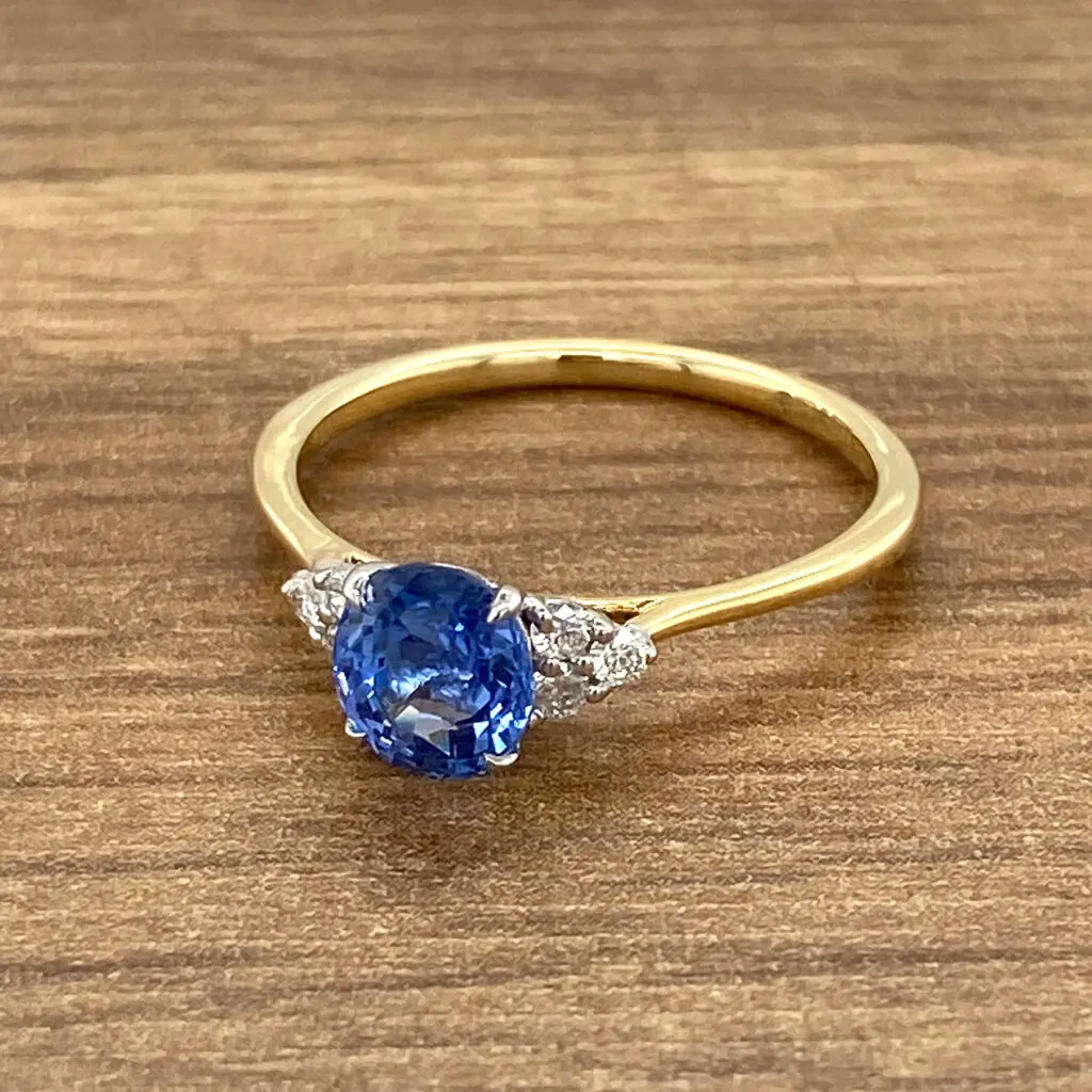 Gold ring with blue sapphire and diamonds.