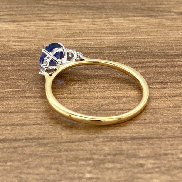 Gold ring with blue sapphire and diamonds.