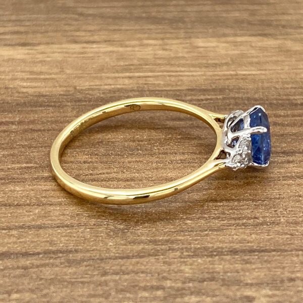 Gold ring with blue sapphire and diamonds.