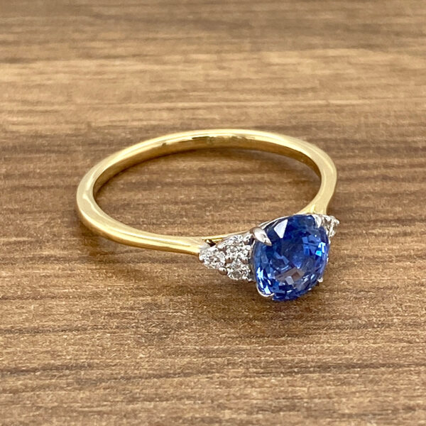 Gold sapphire ring with diamond accents.