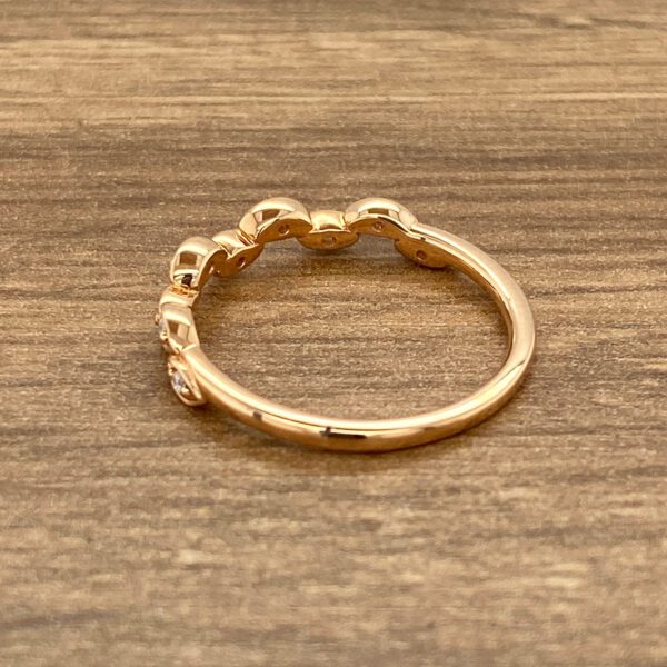 Rose gold ring with five diamonds.