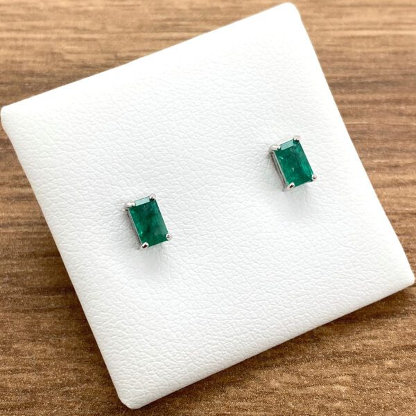 Emerald stud earrings on display.