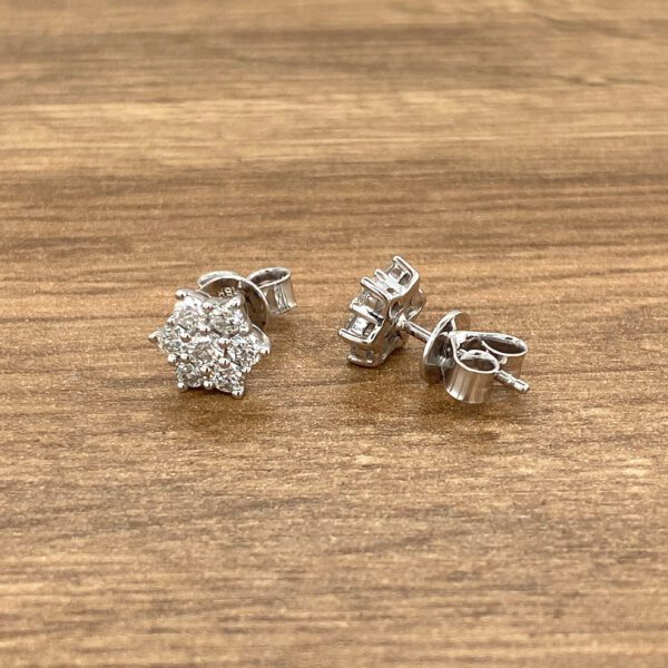 Diamond flower stud earrings in white gold.