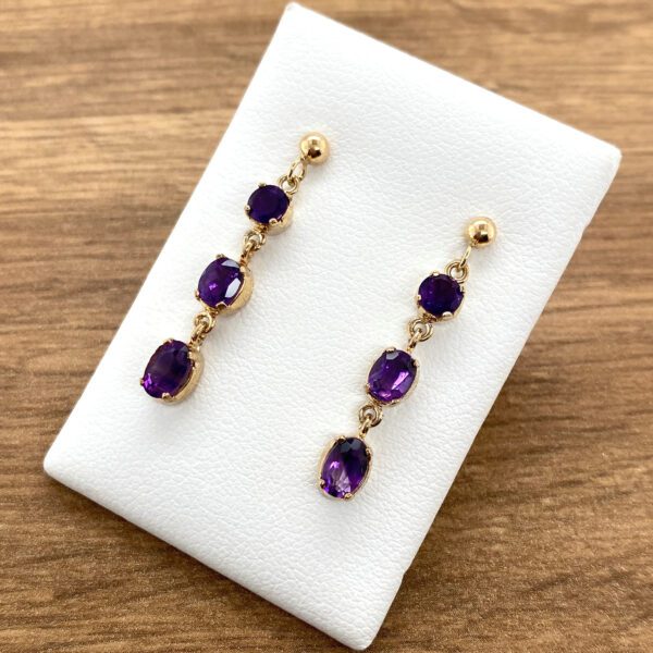 Amethyst and gold drop earrings.