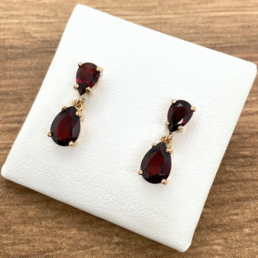 Garnet pear drop earrings in gold.