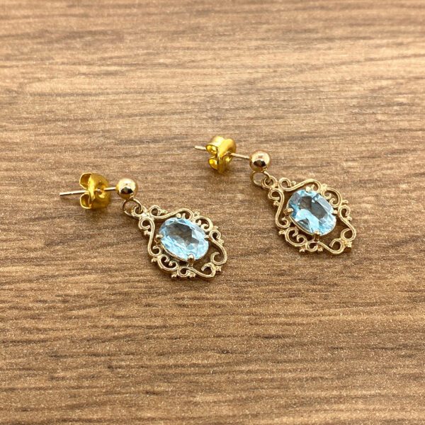 Gold earrings with blue stones.