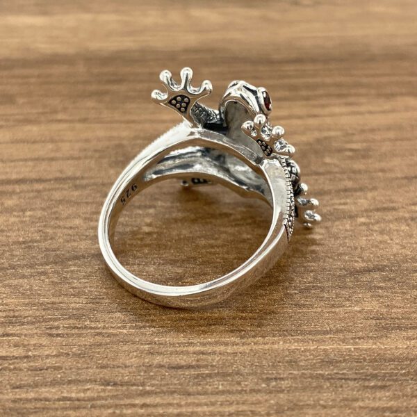 Silver frog ring with red stone.